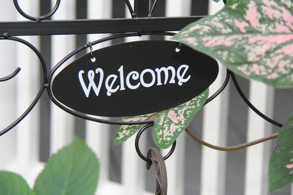 Welcome sign surrounded by foliage