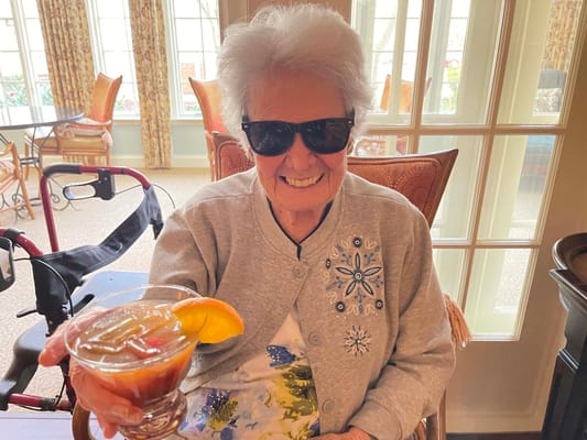 Resident enjoying a refreshing drink indoors