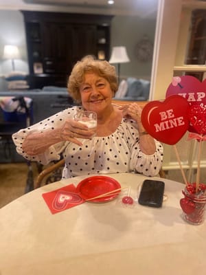 Resident enjoying a drink at a festive table setting