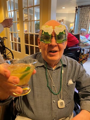 Resident celebrating with drink and festive glasses