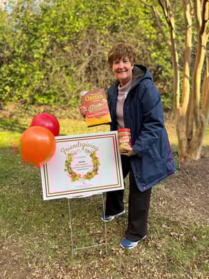 Resident celebrating Friendsgiving outdoors with decorations