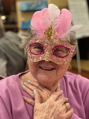 Resident wearing a sparkling mask at a party