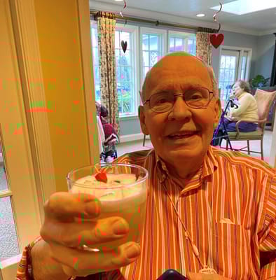 A resident enjoying a drink in a common area