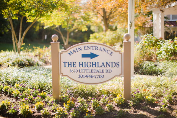 Sign for The Highlands main entrance with landscaped gardens