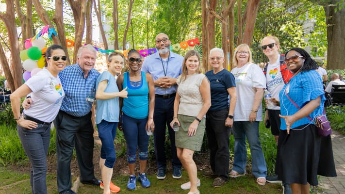 Group of residents and staff celebrating outdoors