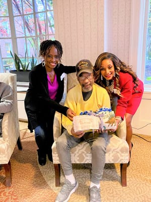 Residents posing with staff in a common area