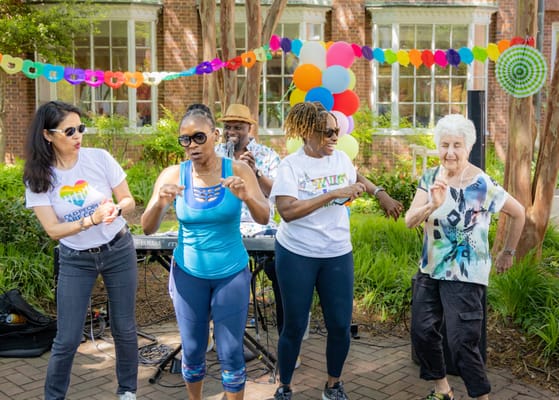 Residents and staff enjoying a lively outdoor event