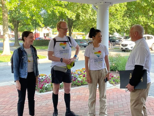 Staff and guests engaging at the facility entrance