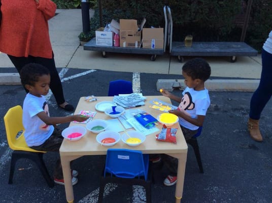 Children engaged in painting activity outdoors