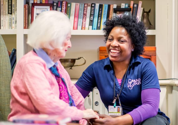 Caregiver interacting with a resident in a cozy living room