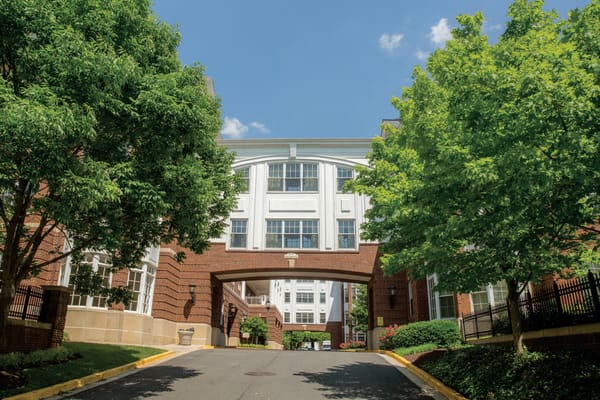 Entrance of a senior living facility with trees