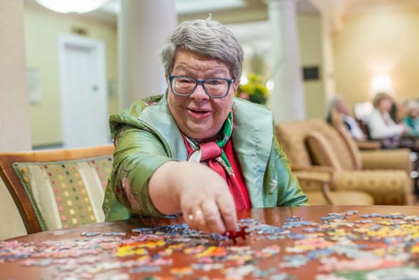 Resident engaging in a puzzle activity at a table