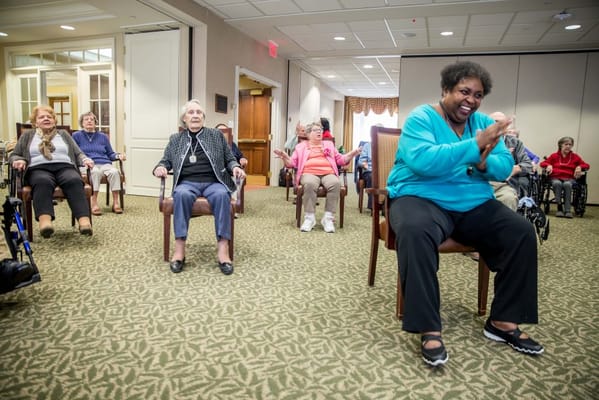 Residents participating in a seated activity within the facility