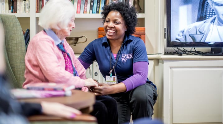 Caregiver interacting with a resident in a common area