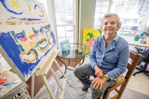 Resident painting in an activity room