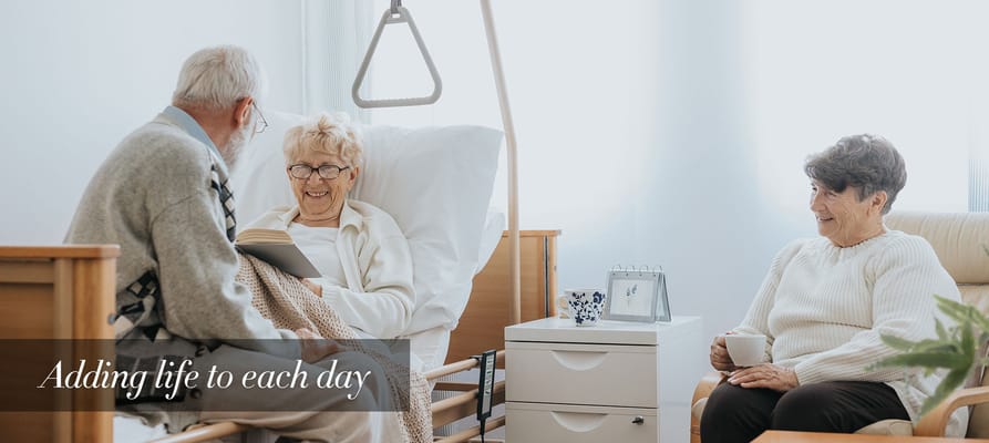 Residents interacting with staff in a cozy room