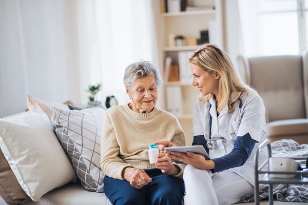 Nurse interacting with a senior resident in a cozy room