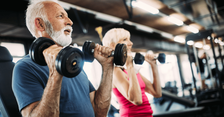 Residents exercising with weights in a fitness area