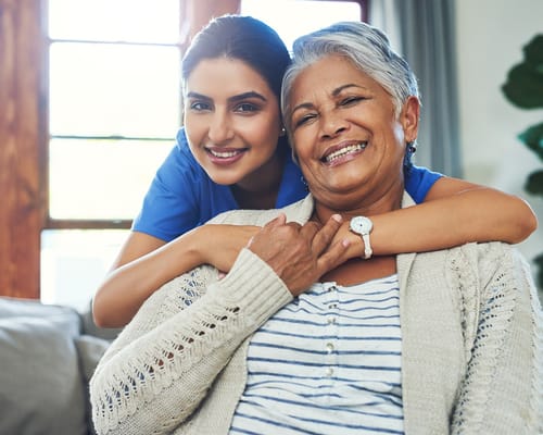 A caregiver and a resident sharing a joyful moment