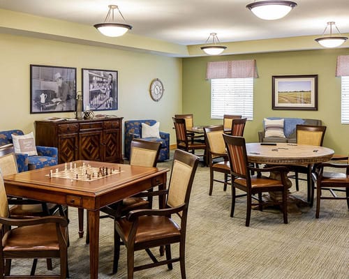 Bright common area with tables and seating for games