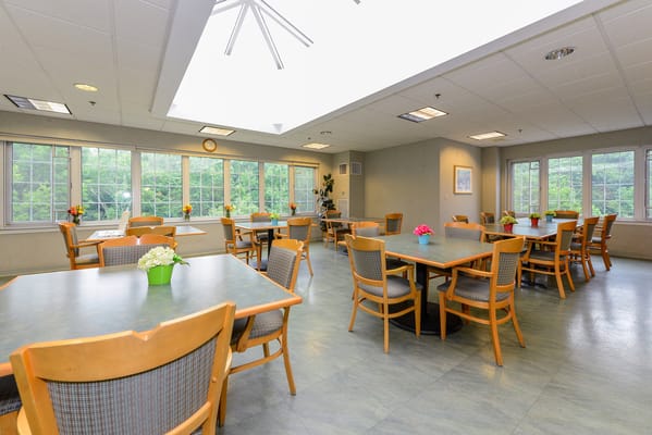 Dining area with tables and chairs in a bright room