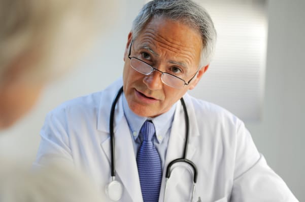 A doctor consulting with a patient in an office