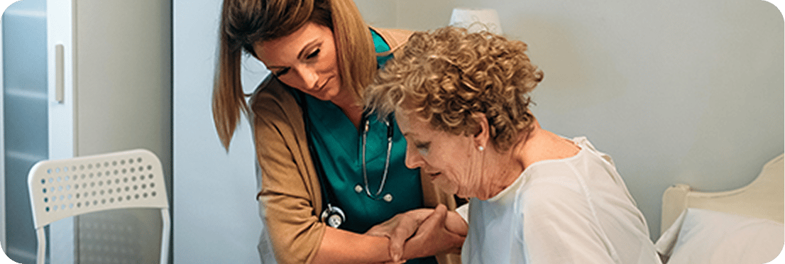 Care staff assisting a resident in a bright room