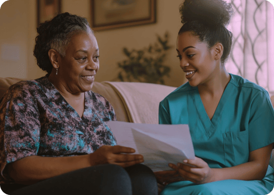 Caregiver and resident sharing a document indoors