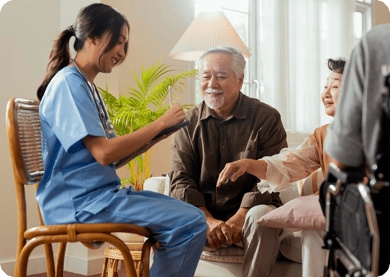 Care staff interacting with senior residents in a cozy living area