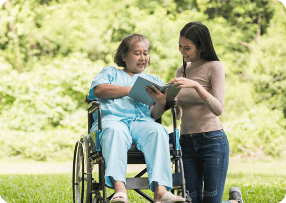A caregiver assisting a resident outdoors