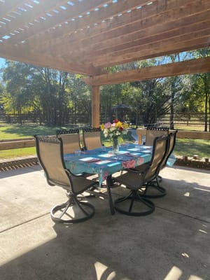 Outdoor dining area with a table and flowers