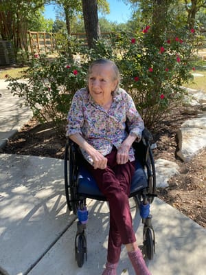 Resident in a wheelchair enjoying the garden area