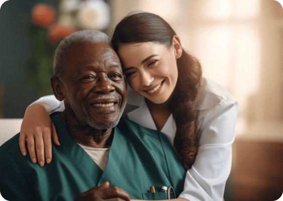 A caregiver and a resident smiling together