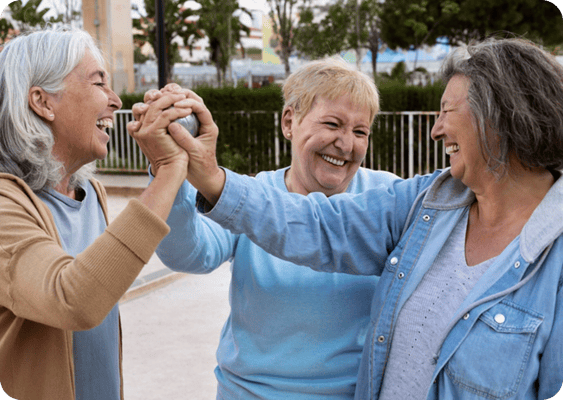 Three residents joyfully interacting outdoors