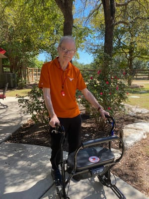 A resident enjoying the outdoors with a walker