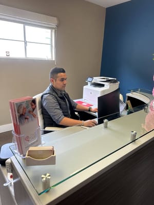 Staff member working at the reception desk