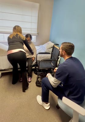 Staff assisting a resident in a room