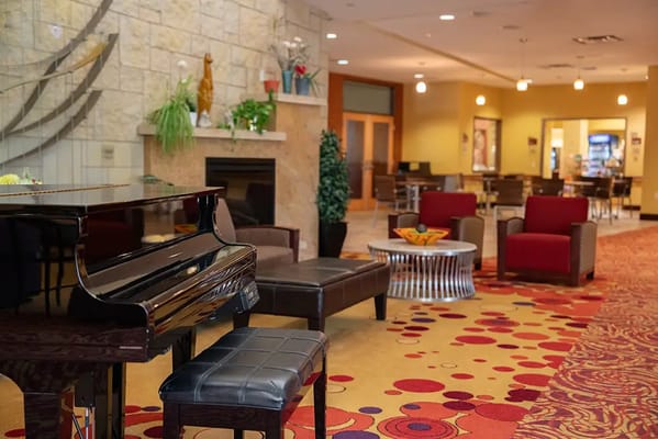 Bright common area with piano and seating