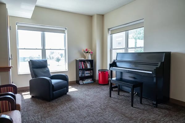 Bright common area with a piano and seating