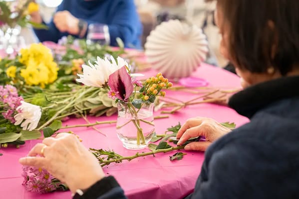 Residents participating in a floral arrangement activity