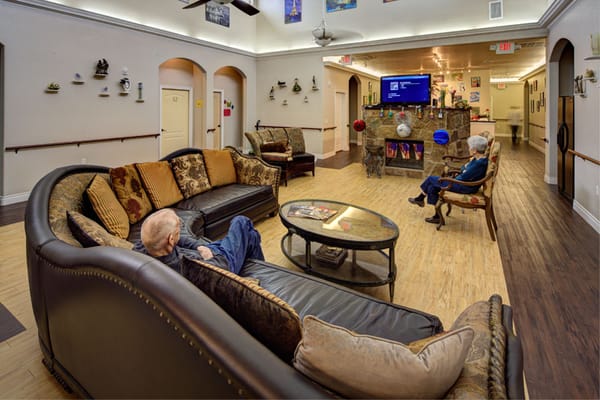 Residents relaxing in a common area with comfy seating