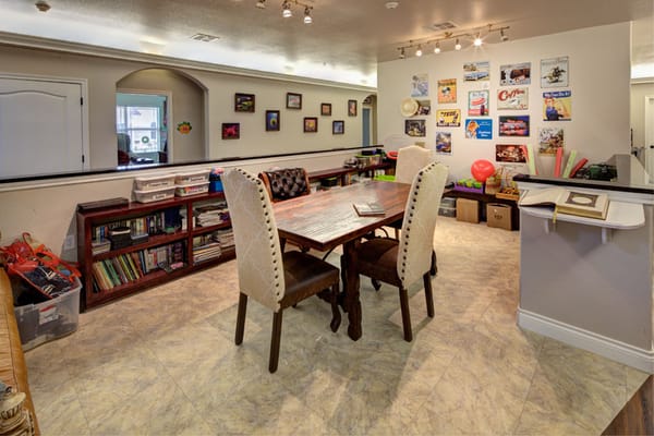 Interior view of a recreational room with a table and shelves