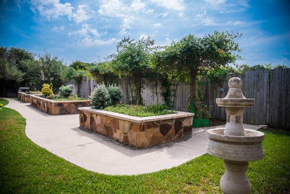 Beautiful landscaped outdoor garden area with seating