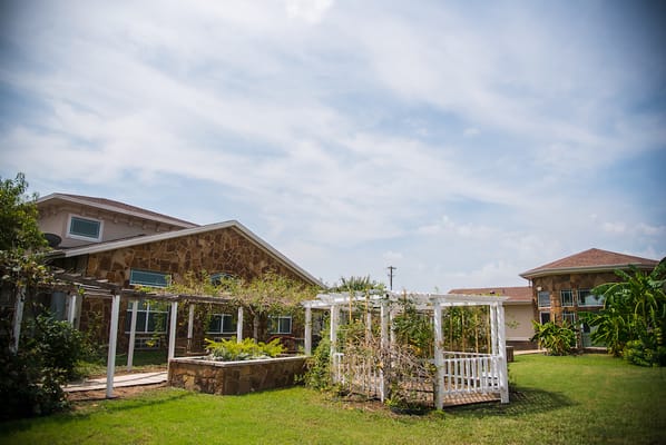 Exterior view of a senior living facility with gardens