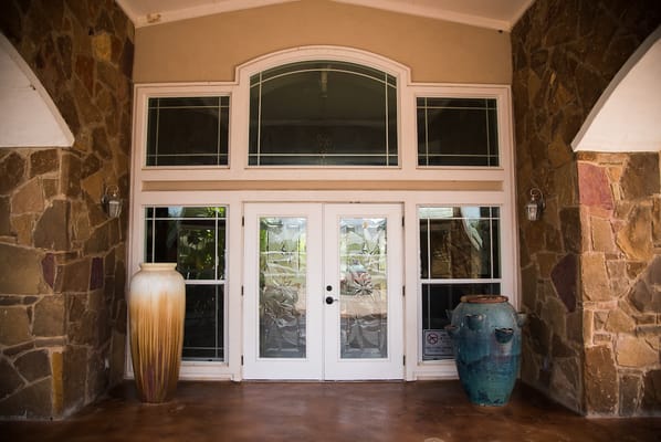 Exterior entrance of the facility with decorative vases