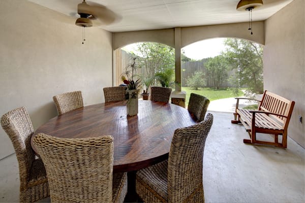 Outdoor dining area with a large table and chairs