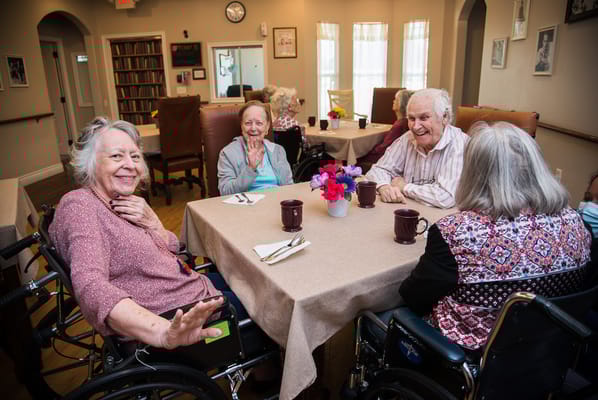 Residents enjoying time together in a dining room