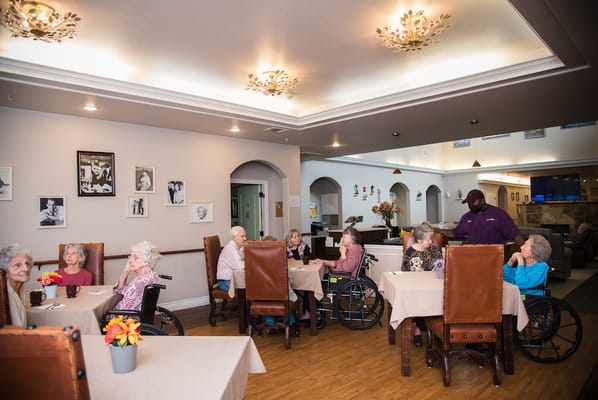 Residents enjoying conversation in a dining area