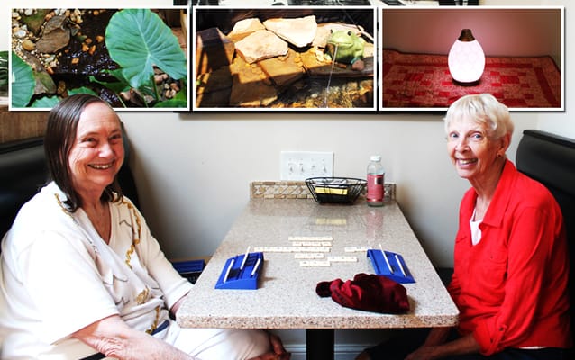 Two residents enjoying a game at a table