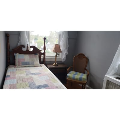 Cozy bedroom with a single bed and chair